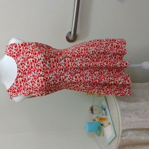 Mini dress or tunic with deep v back and open armpits.  Undergarment required.